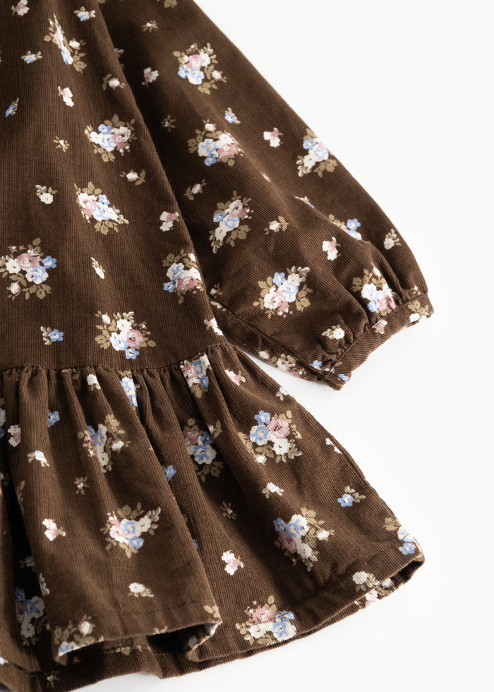 Brown dress with floral print, long sleeves and a ruched waistline.