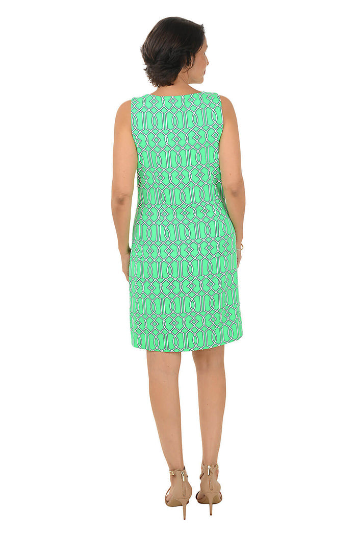 Woman wearing a green patterned dress on a white background