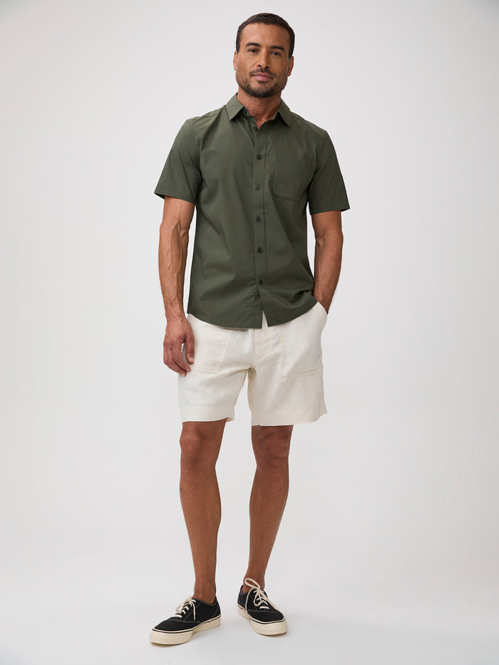 man wearing an Army green shirt bold character on a shirt built for hard use
