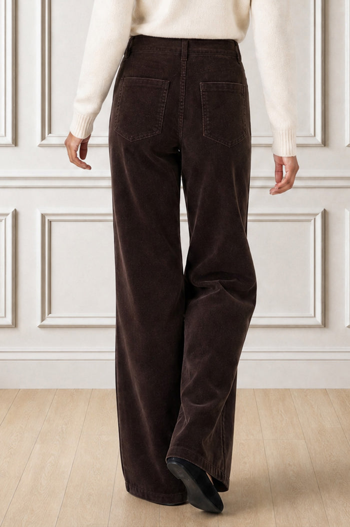 Model wearing the Aspiga Stretch Corduroy Trouser in Chocolate with a cream jumper, back view, full-length