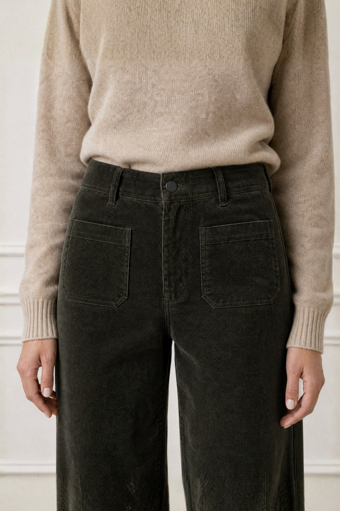 Model wearing the Aspiga Stretch Corduroy Trouser in Khaki, a wide-leg corduroy trouser with patch pockets, alternate view