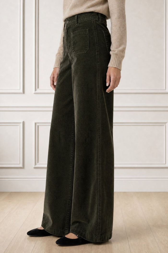Model wearing the Aspiga Stretch Corduroy Trouser in Khaki, a wide-leg corduroy trouser with patch pockets, alternate view