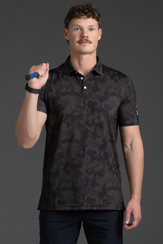 Man wearing a black camouflage polo shirt against a gray background || Black Camo