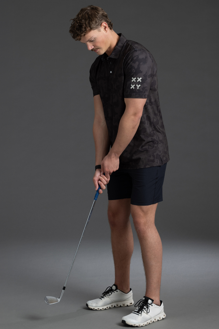 Man holding a golf club on a gray background || Black Camo