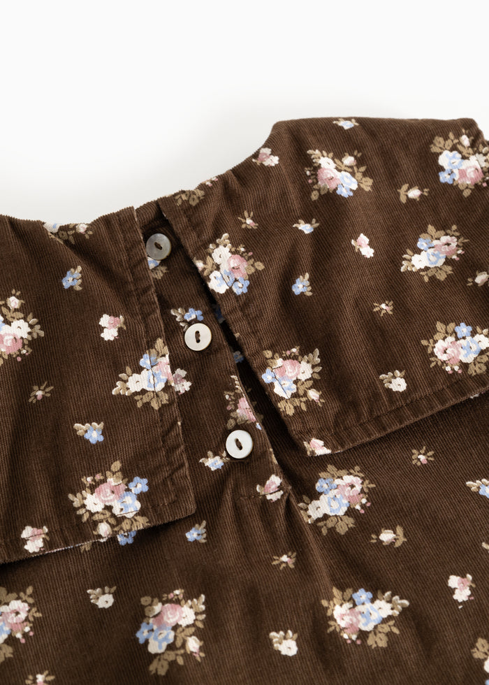 Brown dress with floral print and front button closure.