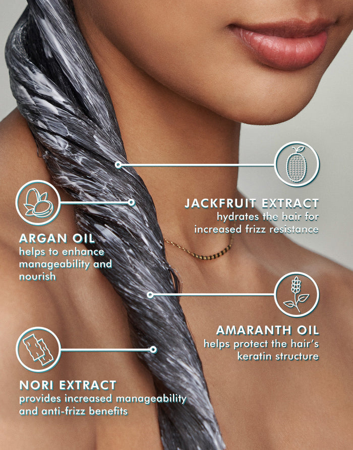 Close-up of a woman with conditioner applied to her hair, highlighting ingredients jackfruit extract, argan oil, amaranth oil, and nori extract with benefits explained, promoting Frizz Control Conditioner | Moroccanoil.