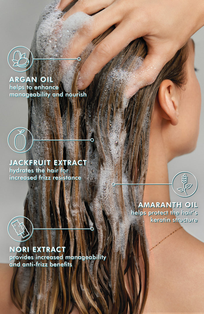 Close-up of a person washing long hair with Frizz Control Shampoo | Moroccanoil, highlighting key ingredients like argan oil, jackfruit extract, amaranth oil, and nori extract for enhanced manageability and frizz resistance.