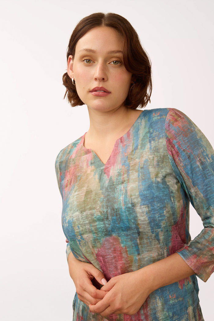 Woman wearing a 3/4 sleeve multicolored top