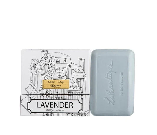 A white box of Lothantique bar soap with a drawing of a cityscape and labelled with the scent Lavender, beside a light blue bar of soap.