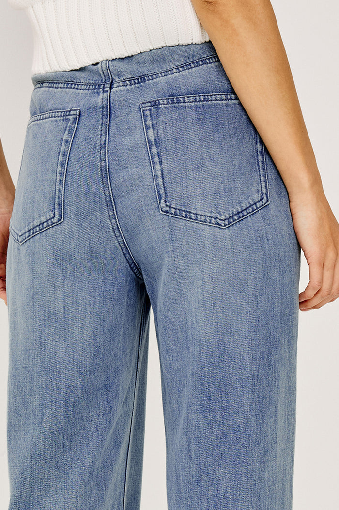 Normandie Pant in Cotton Lyocell Denim With Low-Slung Fit, Adjustable Toggle Drawstring Waist Ties, 5-Pockets, and Loose Fit in Antique Blue Colorway - Close up Back View Featured on Model