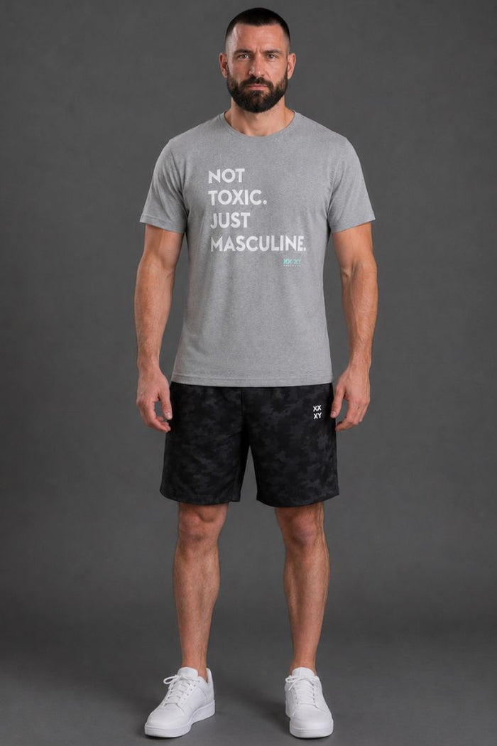 Man wearing a gray t-shirt with text and black shorts on a gray background || Light Heather Gray