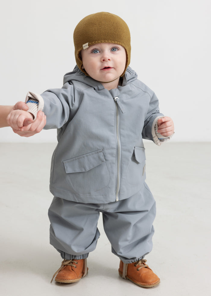 Children wearing gray overalls and matching jackets.