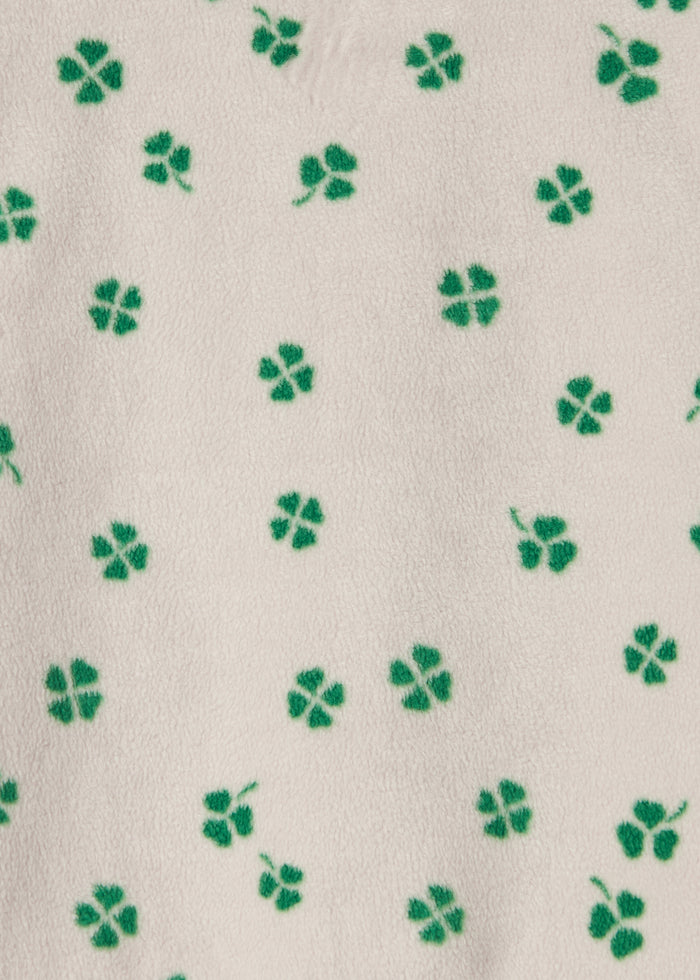 Beige fabric with green clover print