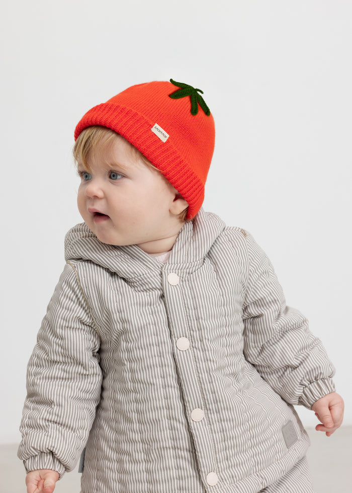 Baby brown thermal jacket with buttons and a red knitted hat