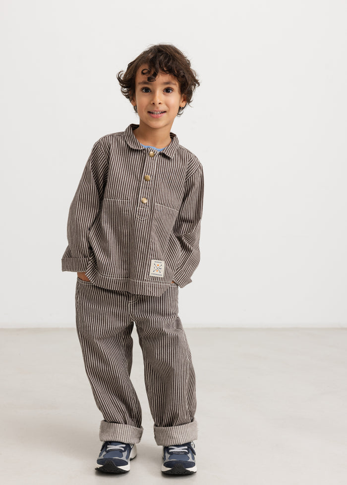 Dark brown striped children's pants with elastic waist and two front pockets and brand.
