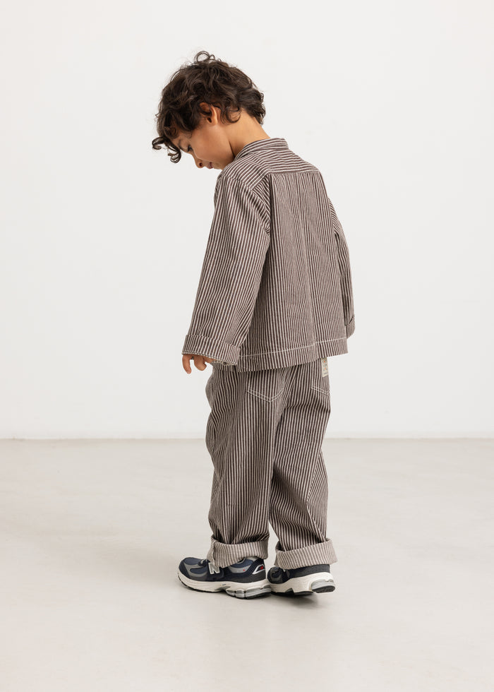 Kids' trousers in dark brown with thin white stripes, shown from the side with a straight fit.