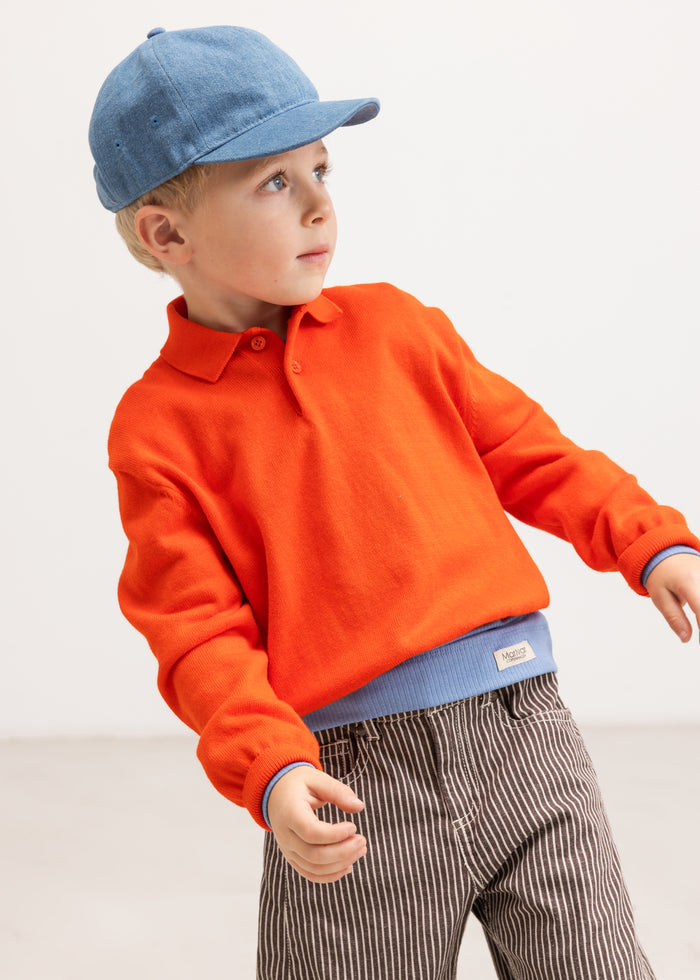 Close-up of dark brown striped trousers with elastic waist and front pockets.
