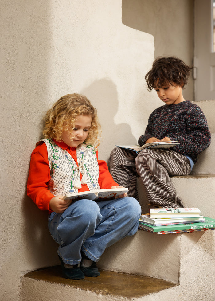 Striped children's pants in dark brown/gray with straight legs.