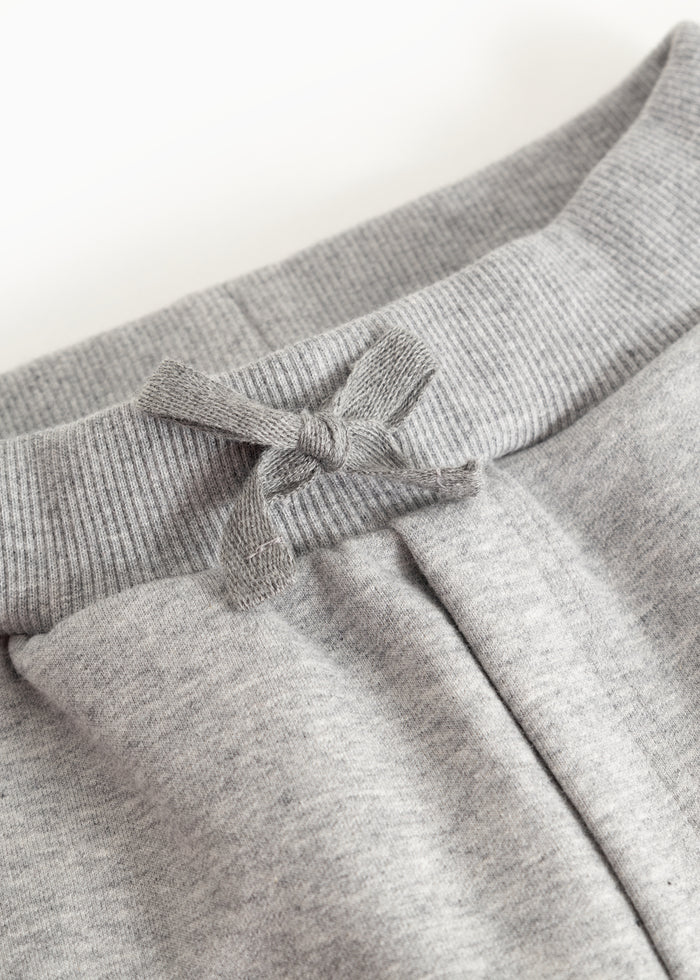 Details of gray jogger pants: drawstring and elastic waistband at the waist.