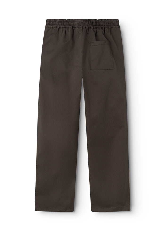 Dark trousers with elastic waistband, side pockets, and straight, loose legs.