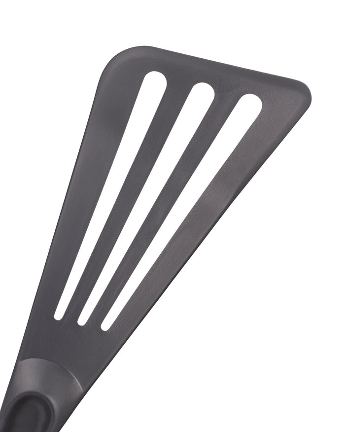 Grey slotted spatula on a white background