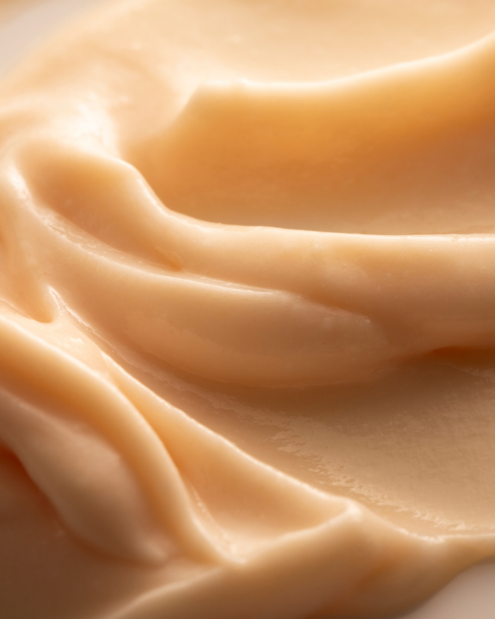 Close-up texture of creamy exfoliating mask with smooth, rich consistency, showcasing Superfruit Lactic + Multifruit 8% AHA Exfoliating Mask | Three Ships for skincare.