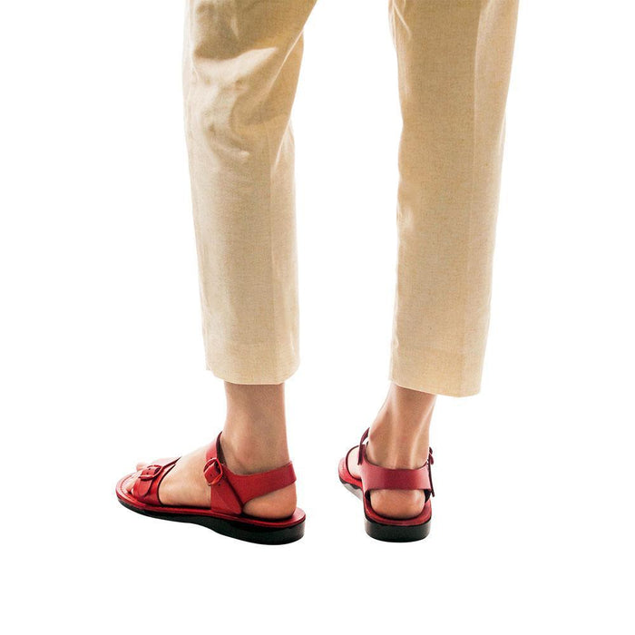 Model wearing The Original red, handmade leather sandals with back strap