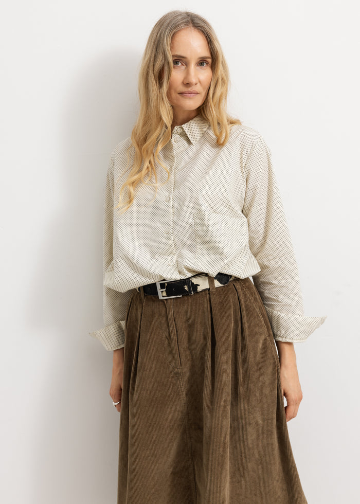 White shirt with small black dots, long sleeves and button collar