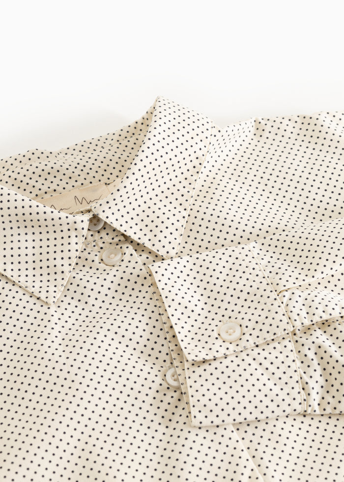 Off-white shirt with small black dots, button collar and front button closure.