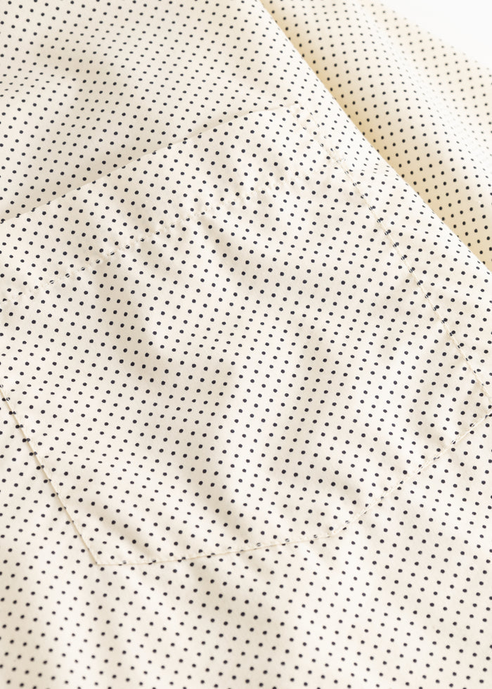 Off-white shirt fabric with small black dots