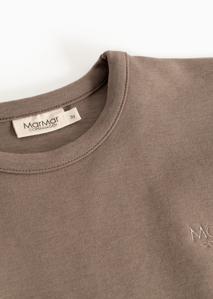 Dusty brown blouse with round neckline and MarMar brand at the neck.
