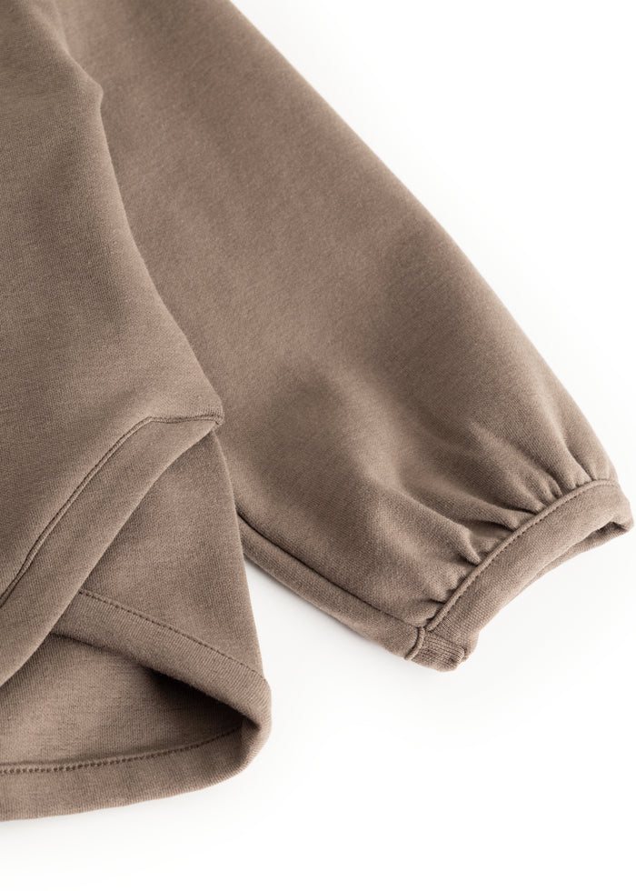 Dusty brown blouse with round neck and visible cuffs