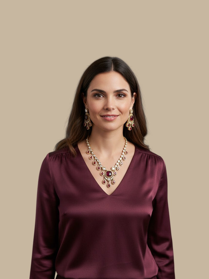 Kurti Connection USA ethnic jewelry set with ruby-red stones and antique-gold finish worn by a woman in a silk top.