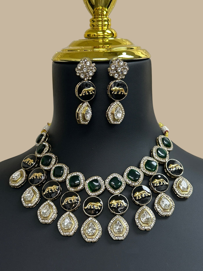 Kurti Connection USA multi-layered necklace and earring set with emerald green stones, black animal motifs, and gold.