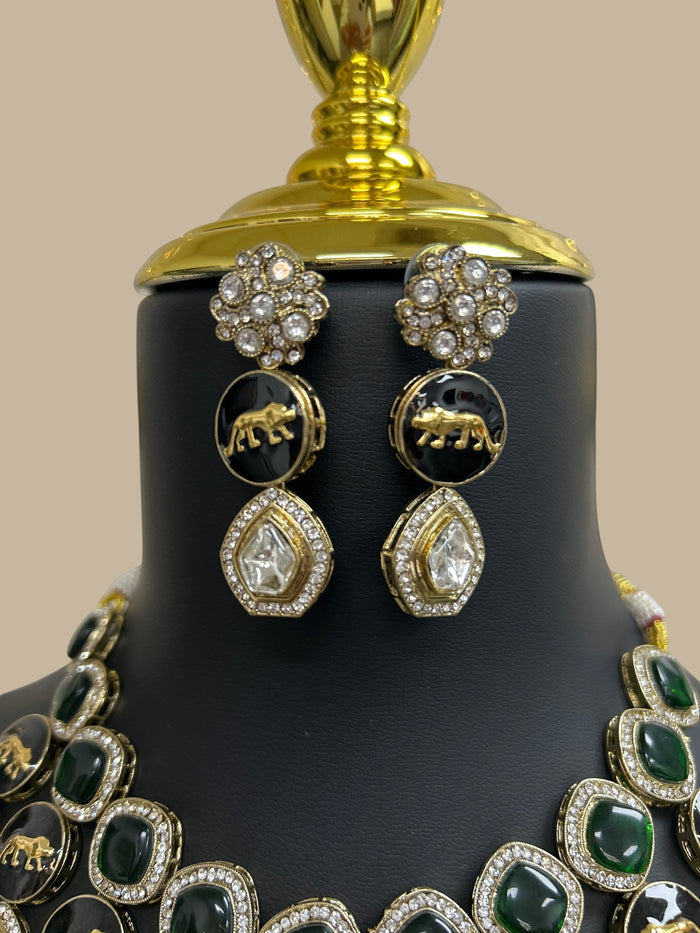 Kurti Connection USA ethnic jewelry set with emerald green stones, black animal motifs, and sparkling white crystals.
