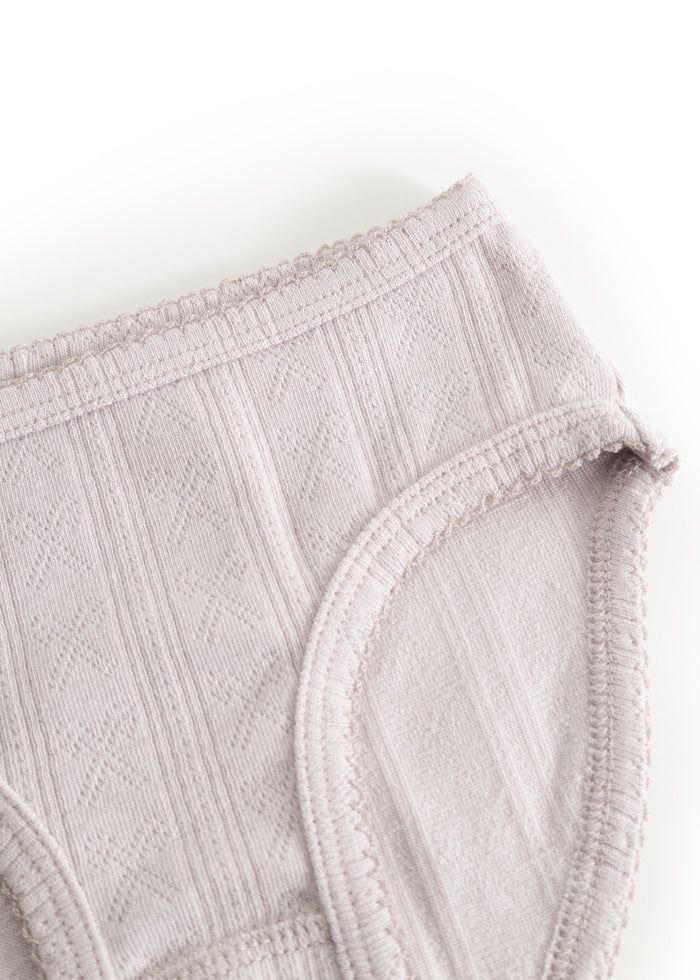 Light pink panties with elastic waist and leg openings, visible seam edge.