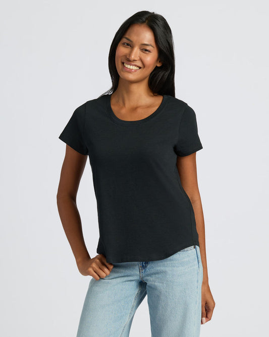 Woman wearing Womens Black Slub Scoop Neck Tee with jeans, smiling. MODEL_INFO: Candy is 5'9", wearing a size S