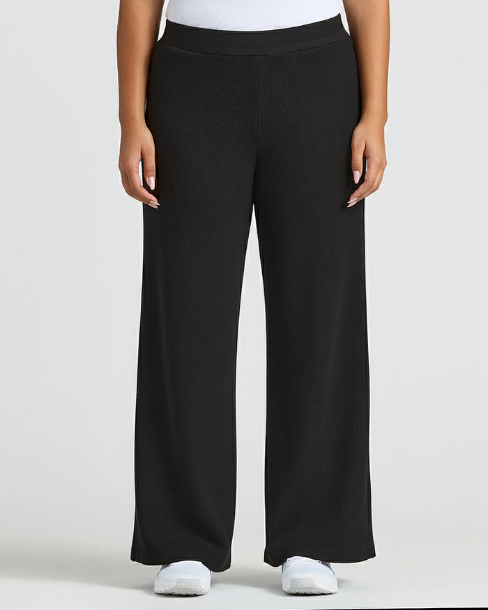 Womens Black Waffle Wide Leg Pants styled with white top and sneakers. MODEL_INFO: Jade is 5'9", wearing a size L