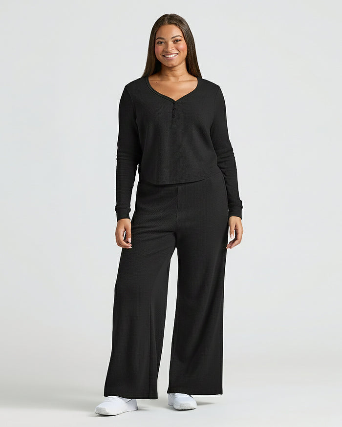 Woman in Womens Black Waffle Wide Leg Pants, modeling cozy lounge set.