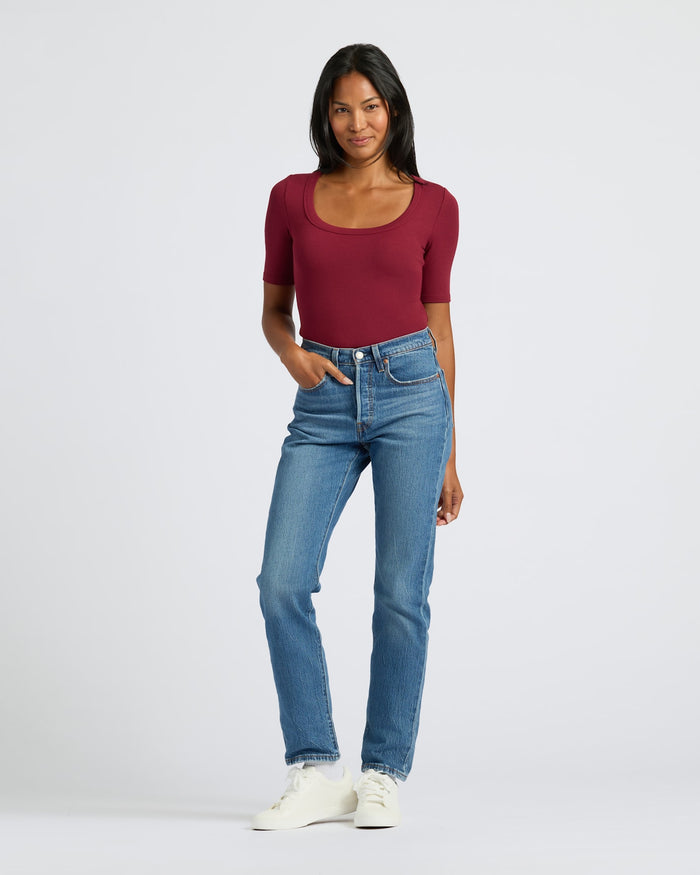 Woman modeling Womens Dark Maroon Ribbed 3/4 Sleeve Scoop Neck Tee with jeans.
