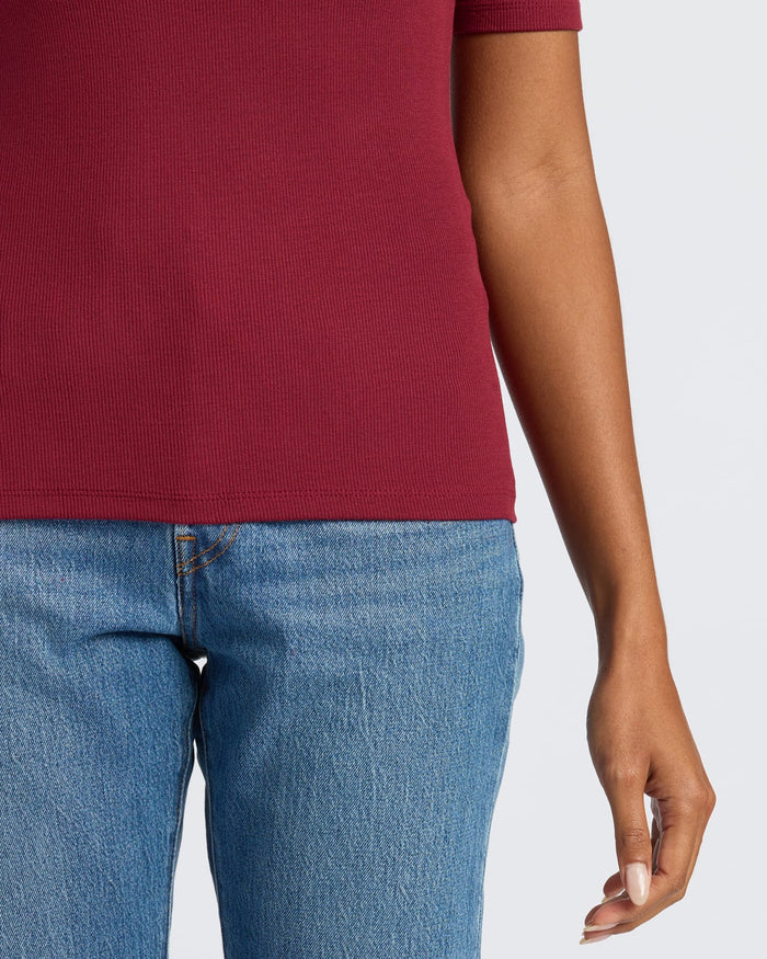 Womens Dark Maroon Ribbed 3/4 Sleeve Scoop Neck Tee tucked into jeans.