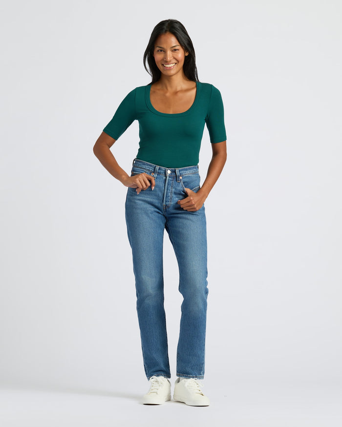 Woman wearing Womens Deep Emerald Ribbed 3/4 Sleeve Scoop Neck Tee and jeans.