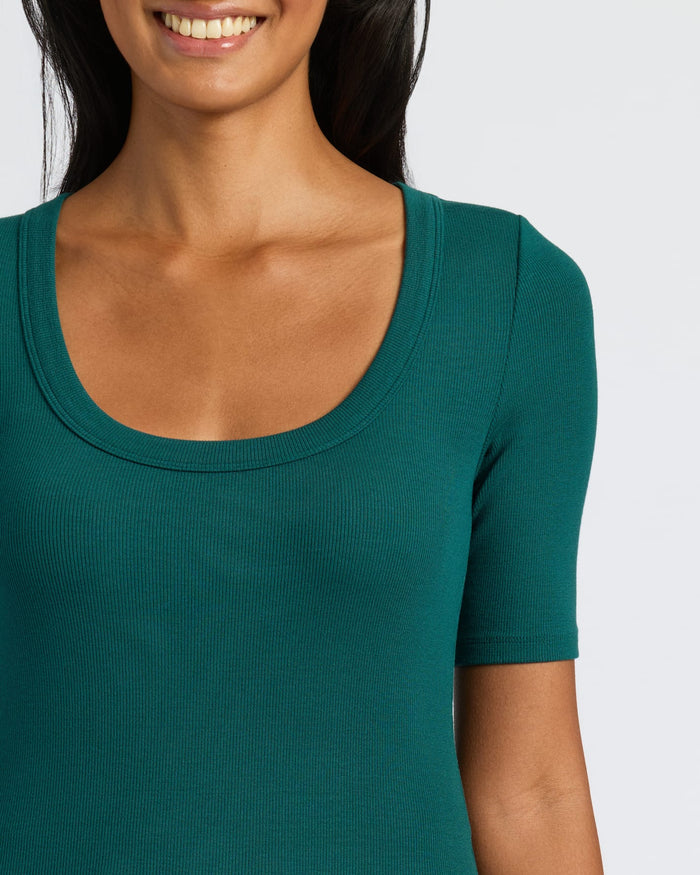 Woman wearing the Women's Deep Emerald Ribbed 3/4 Sleeve Scoop Neck Tee.
