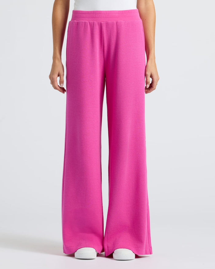 Womens Electric Fuchsia Waffle Leg Pant with white sneakers.