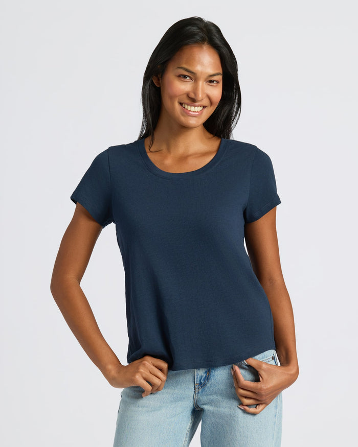 Woman in Womens Navy Slub Scoop Neck Tee with jeans, smiling. MODEL_INFO: Candy is 5'9", wearing a size S