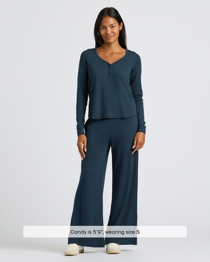 Woman modeling Womens Navy Waffle Wide Leg Pants with henley-style top.