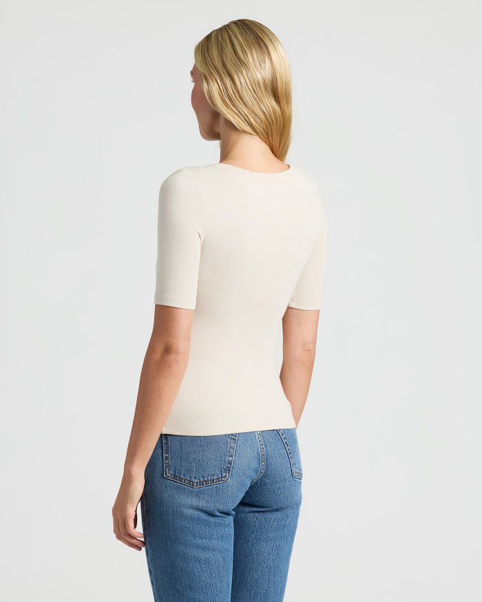 Woman in cream Womens Ribbed 3/4 Sleeve Scoop Neck Tee.