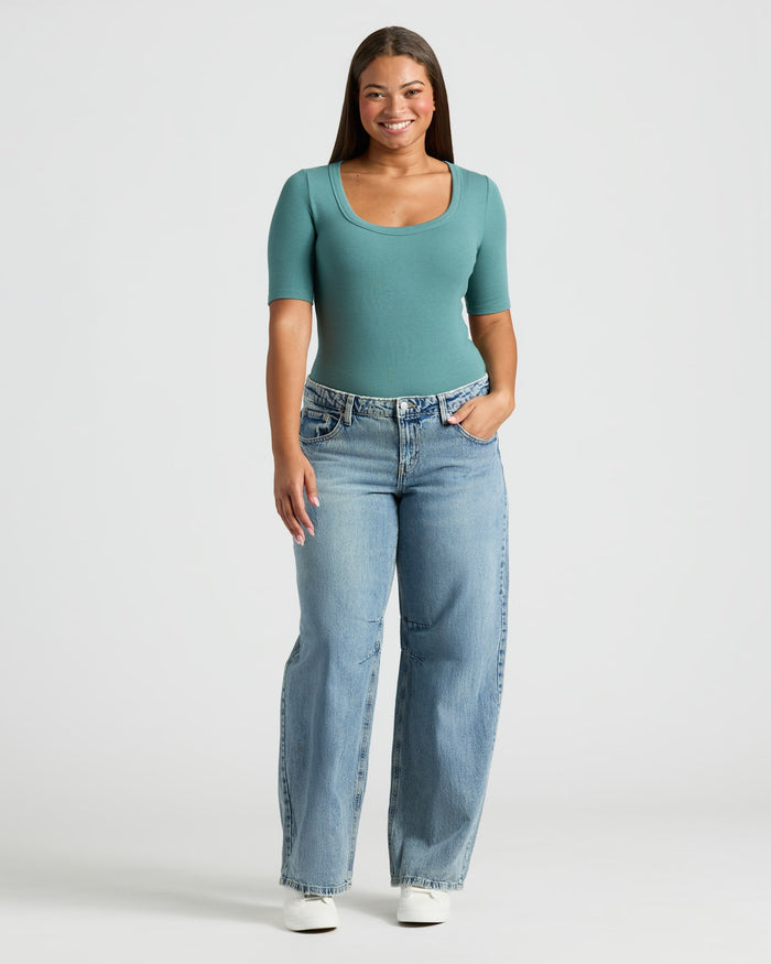 Woman wearing Womens Ribbed 3/4 Sleeve Scoop Neck Tee, teal, with jeans.