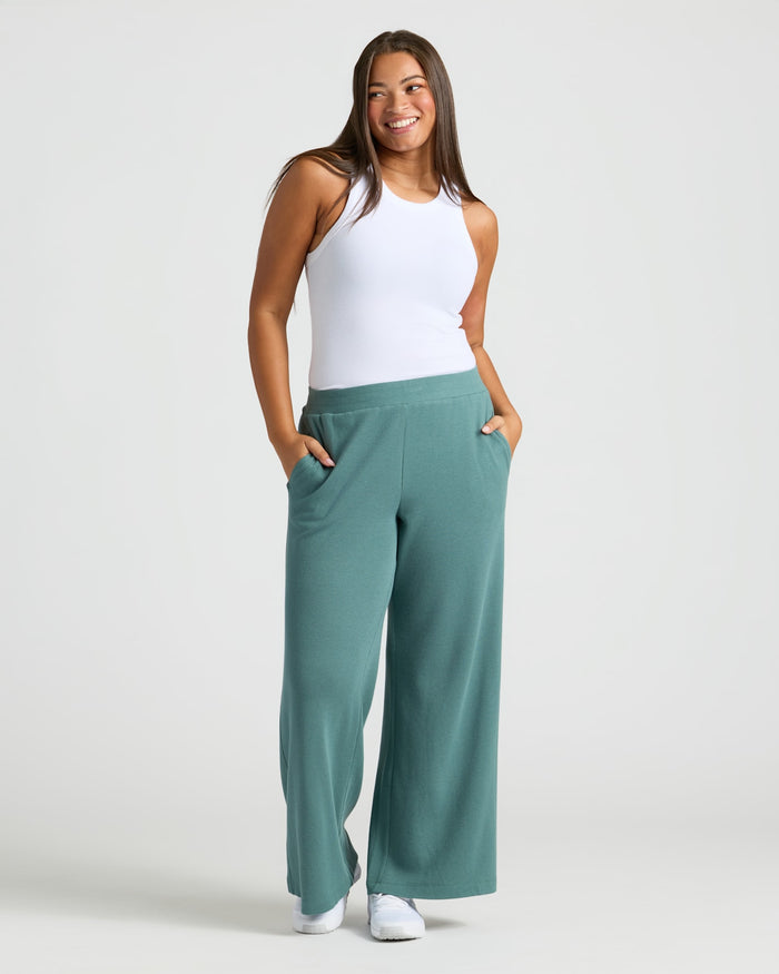 Woman in Womens Stormcloud Waffle Wide Leg Pants, hands in pockets. MODEL_INFO: Jade is 5'9", wearing a size L
